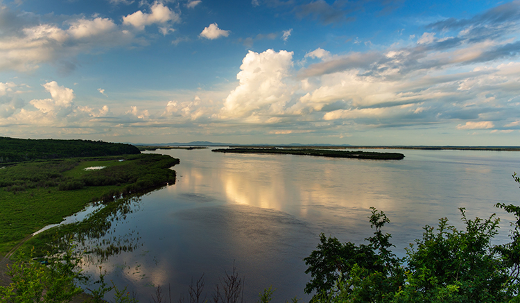 Photo shows the lower course of the River near the city of Komsomolsk-on-Amur. On the horizon of the visible bridge across the River, beautiful beaches, powerful water flow. The Amur River, the largest river in the far East.