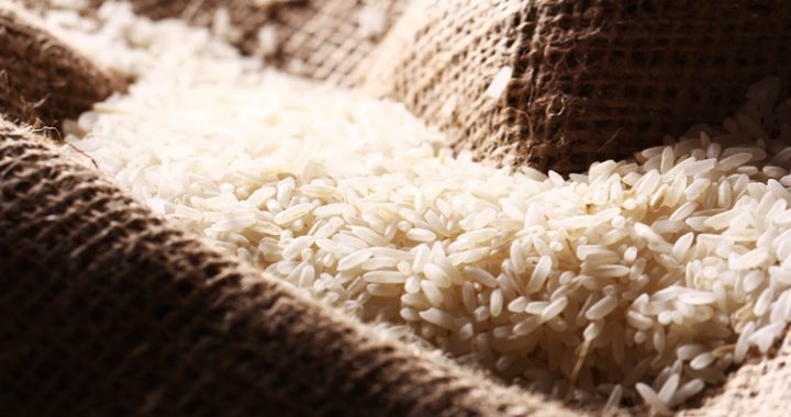 Close up of white rice grains on the sack cloth